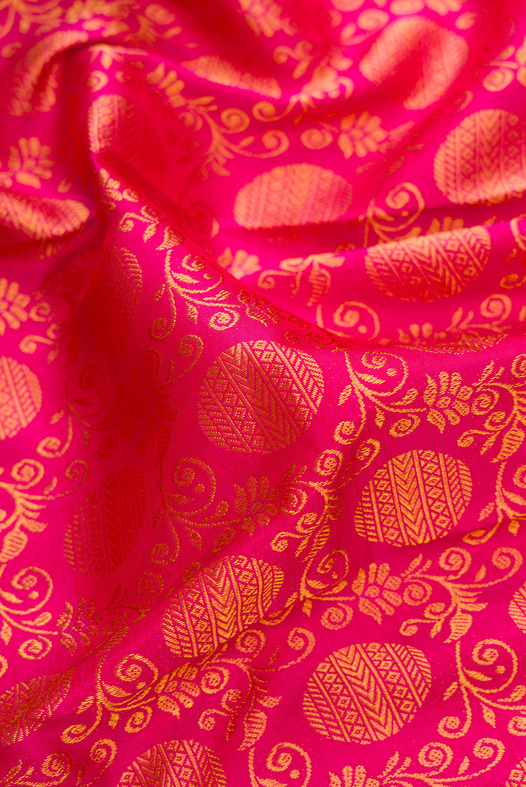 Close up of Pink Kanjivaram Silk Saree with Zari Brocade on the body and Zari Border.  displaying folds