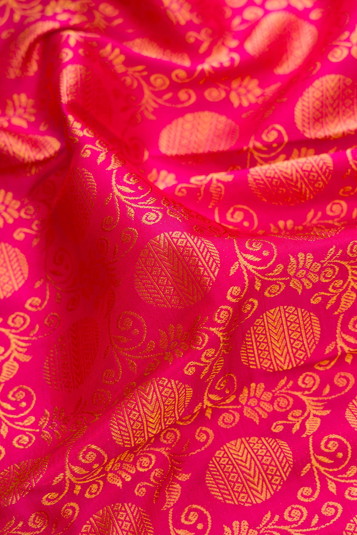 Close up of Pink Kanjivaram Silk Saree with Zari Brocade on the body and Zari Border.  displaying folds