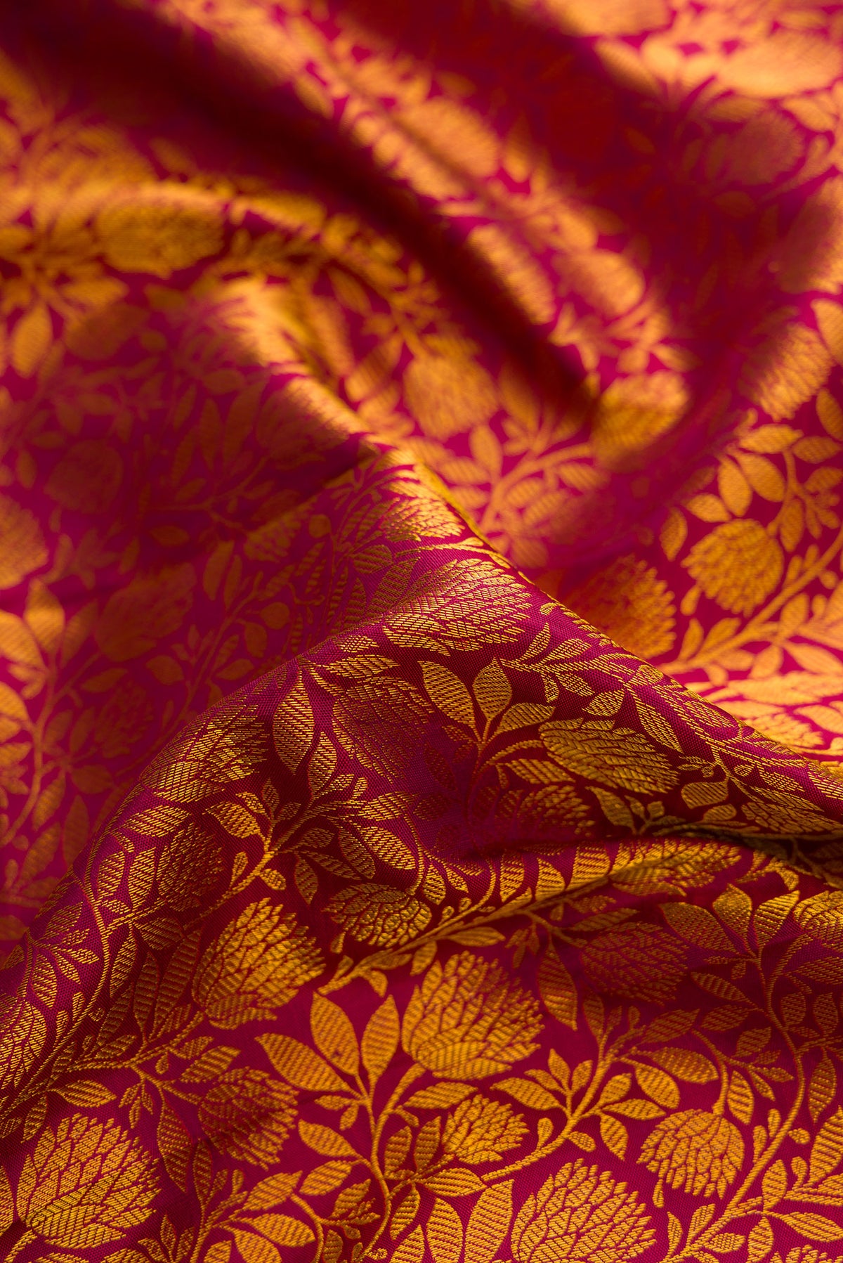 Close up of Maroon Kanjivaram Silk Saree with Zari Brocade on the body and Zari Border.  displaying folds