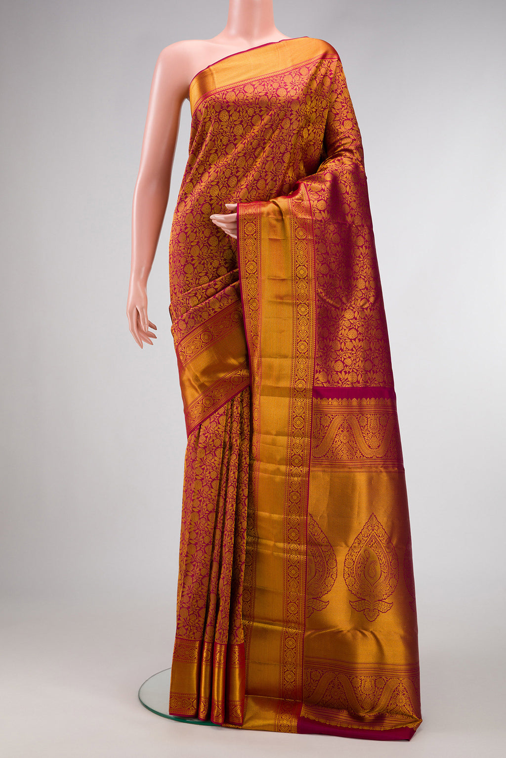 Maroon Kanjivaram Silk Saree with Zari Brocade on the body and Zari Border.  displayed on a mannequin