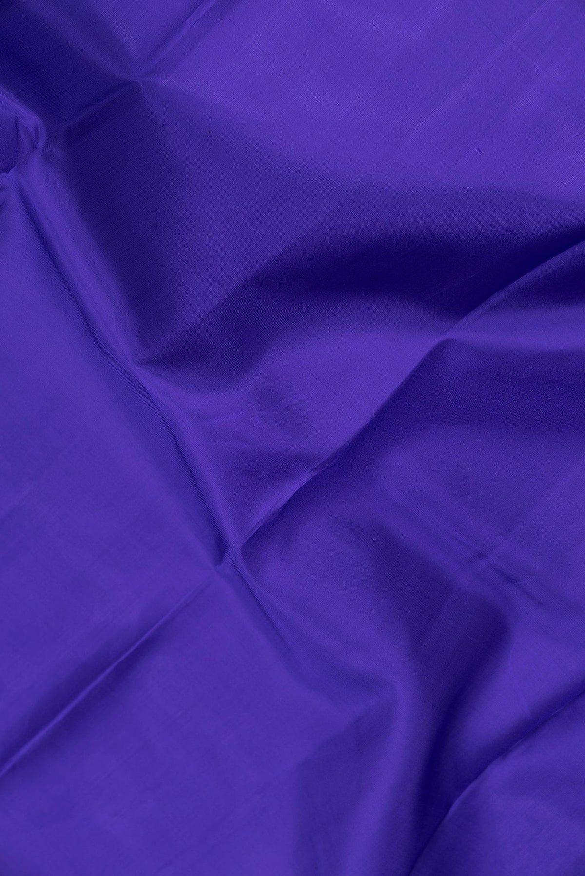 Close up of Royal Blue Dual Tone Kanchipuram Saree with Plain Body and Zari Border.  displaying folds