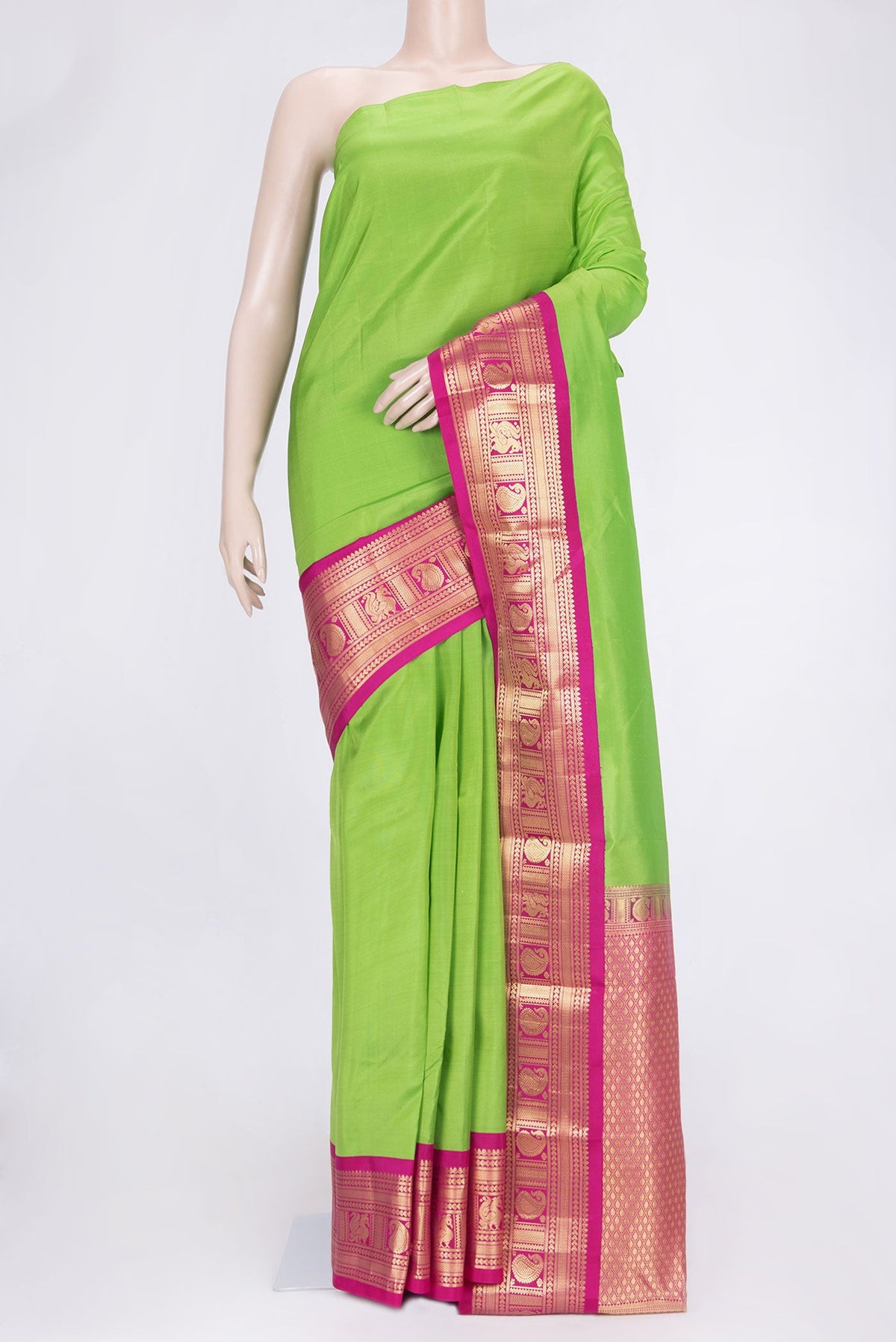 Parrot Green Dual Tone Kanchipuram Saree with Plain Body and Zari Border.  displayed on a mannequin