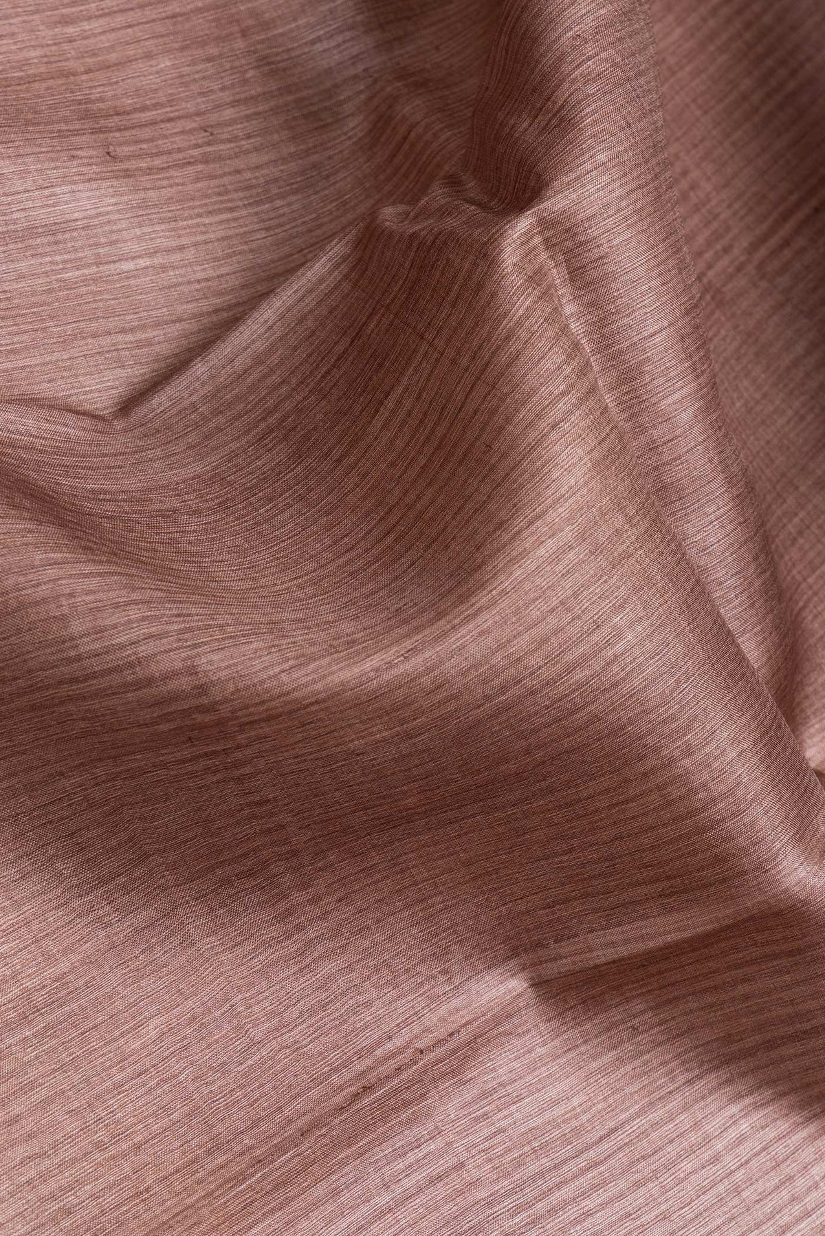 Close up of Brown Dual Tone Tussar Silk Saree with Printed design on the body and Fancy Border.  displaying folds