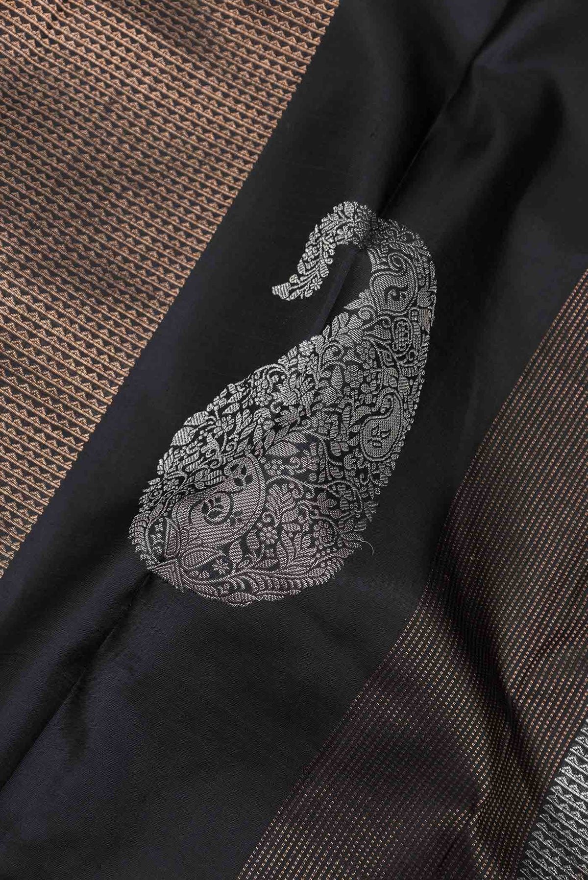 Close up of Black Dual Tone Kanchipuram Silk Saree with Stripes on the body and Without Border displaying folds