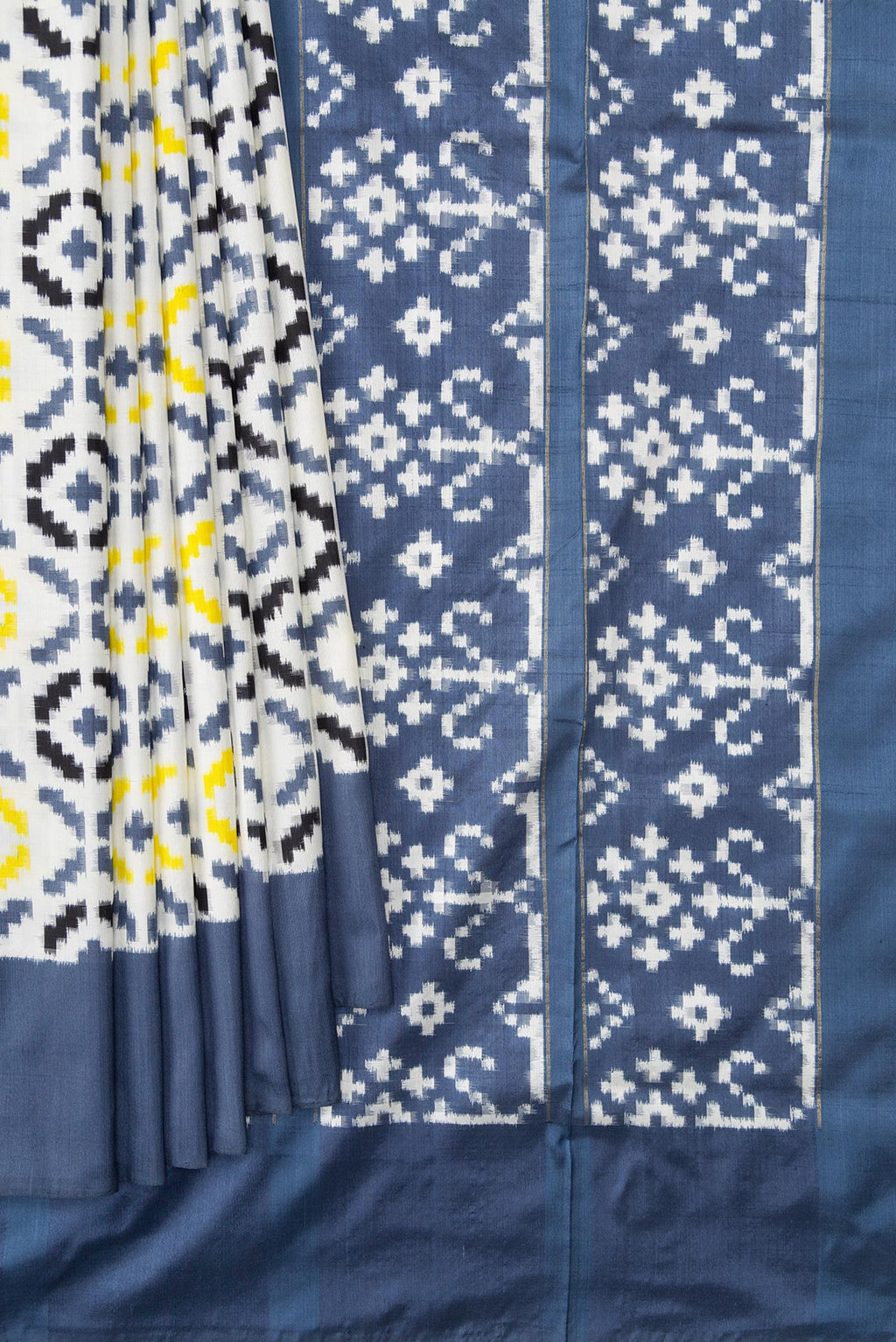 Pleats and pallu of Off White Dual Tone Double Ikat Saree with Ikat Print on the body and Plain Border. 