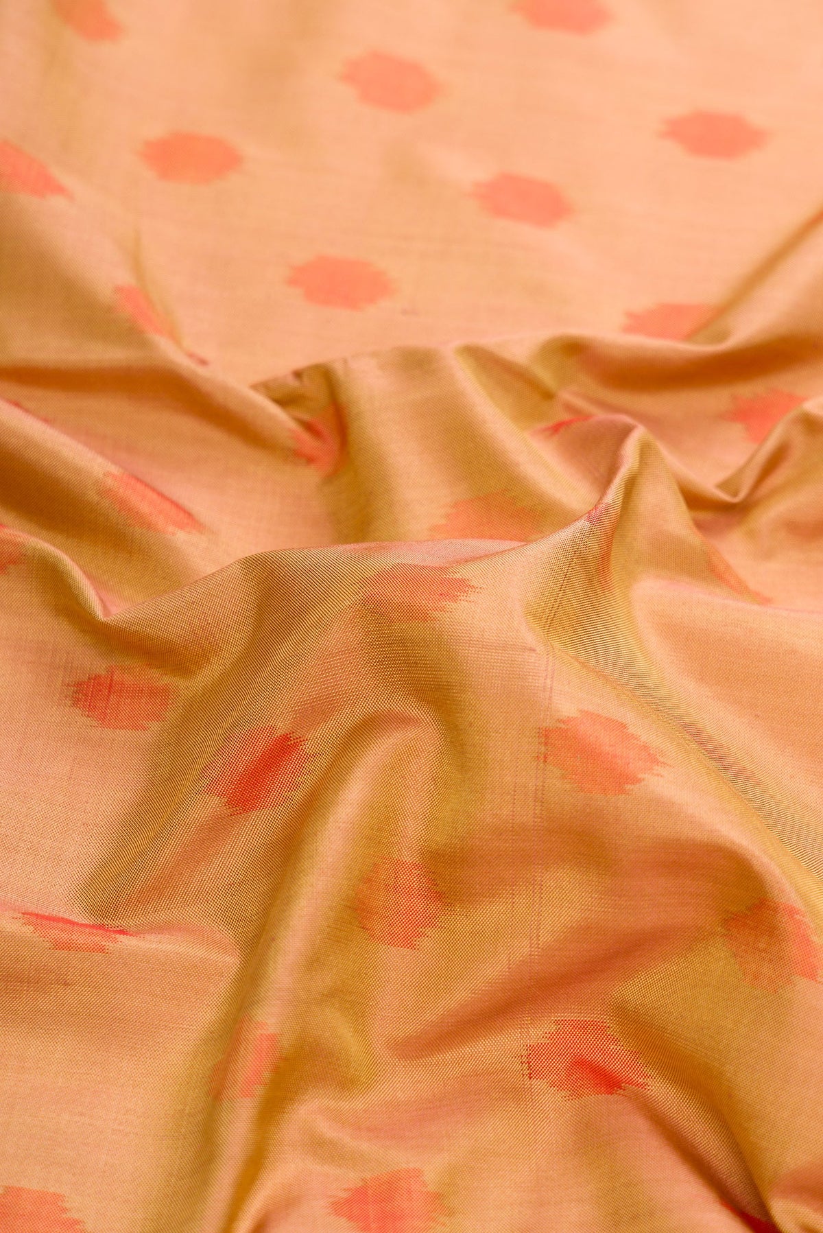 Close up of Gold Dual Tone Double Ikat Saree with Ikat Print on the body and Zari Border.  displaying folds