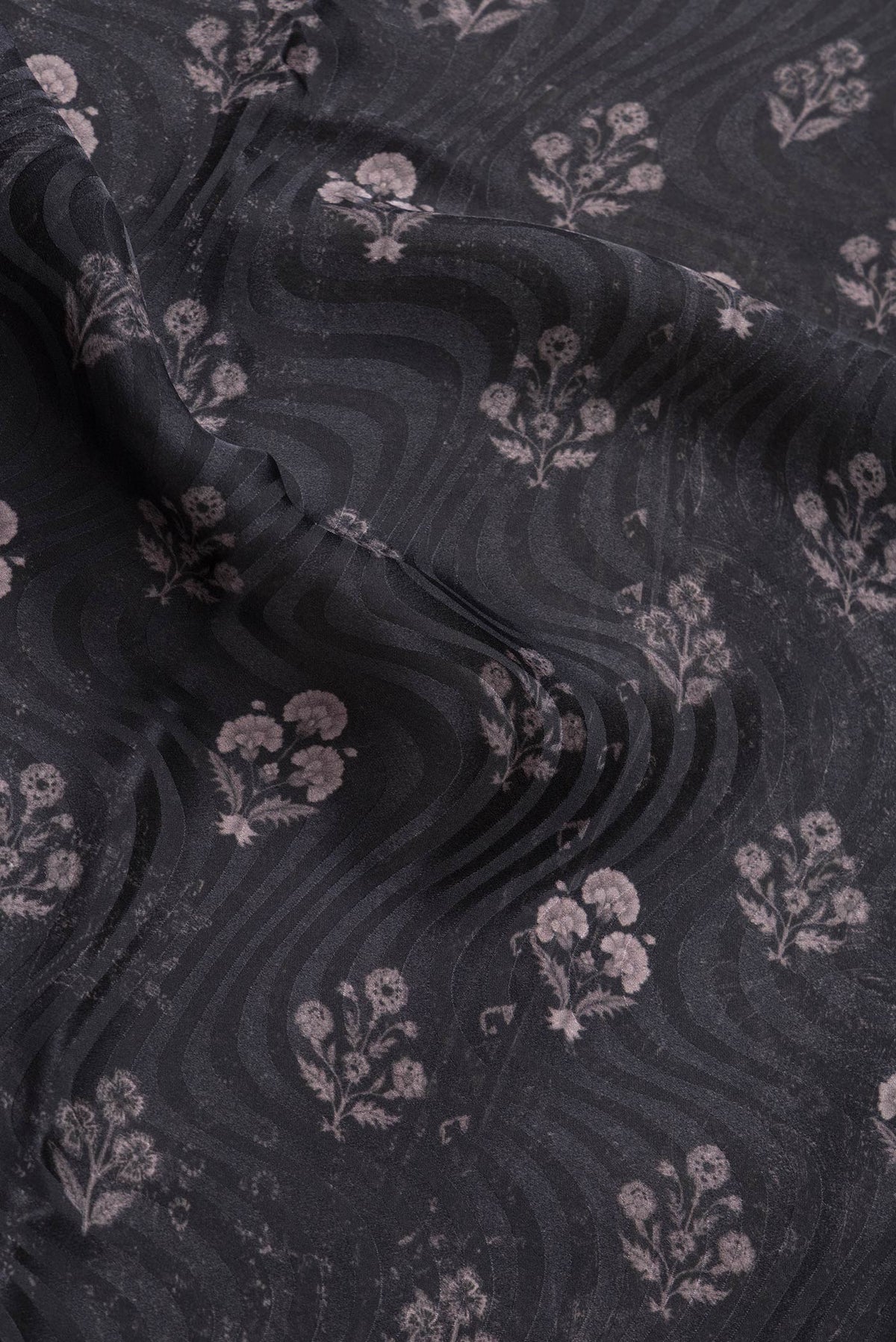 Close up of Black Dual Tone Mysore Crepe Saree with Printed design on the body and Printed Border.  displaying folds