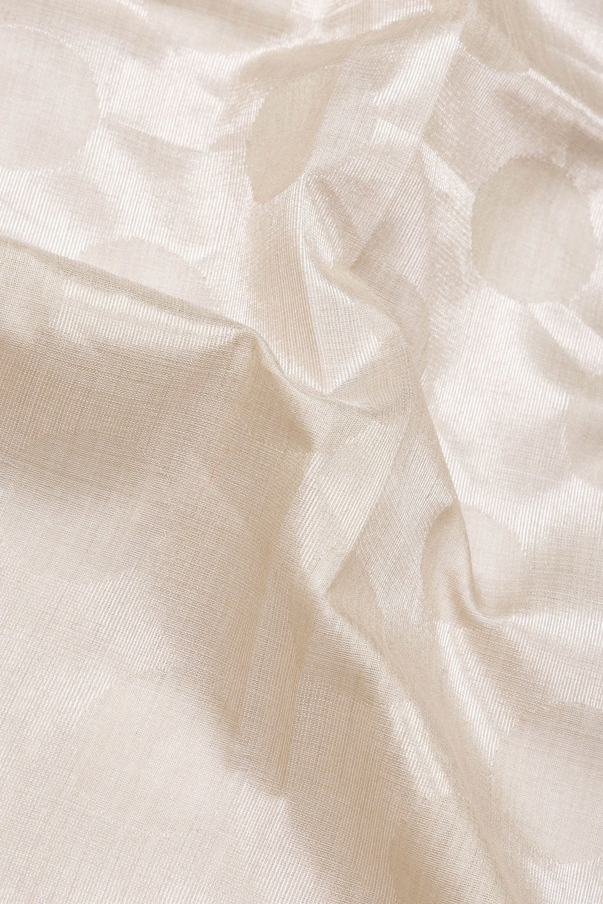 Close up of Beige Dual Tone Tussar Silk Saree with Zari Brocade on the body and Plain Border.  displaying folds