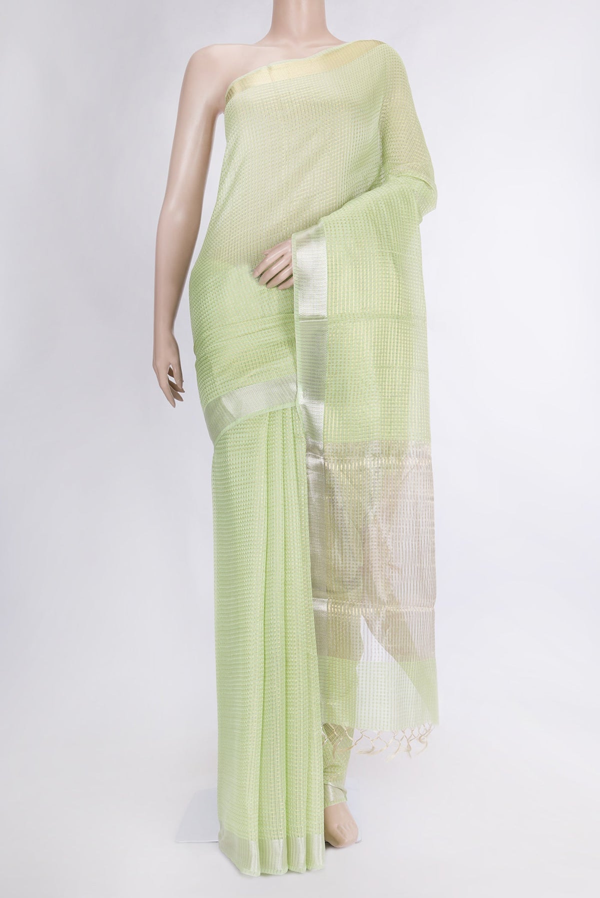 Pista Green Dual Tone Tussar Silk Saree with Checked design on the body and Zari Border.  displayed on a mannequin