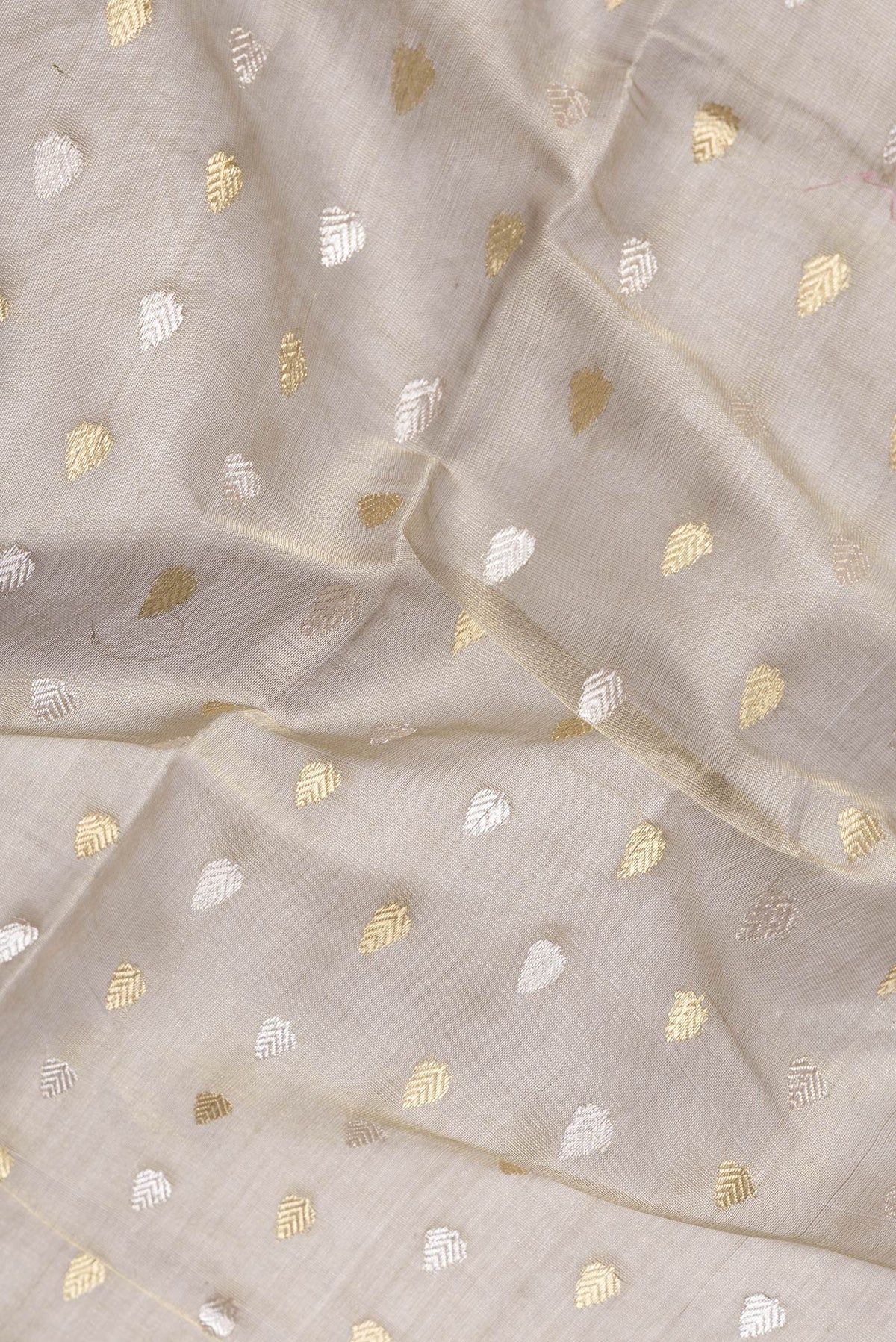Close up of Mehandi Green Dual Tone Tussar Silk Saree with Zari Butta on the body and Thin Zari Line.  displaying folds