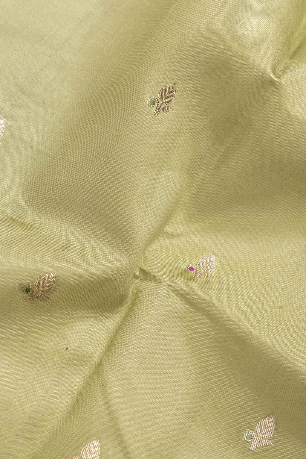 Close up of Mehandi Green Dual Tone Tussar Silk Saree with Zari Butta on the body and Fancy Border.  displaying folds