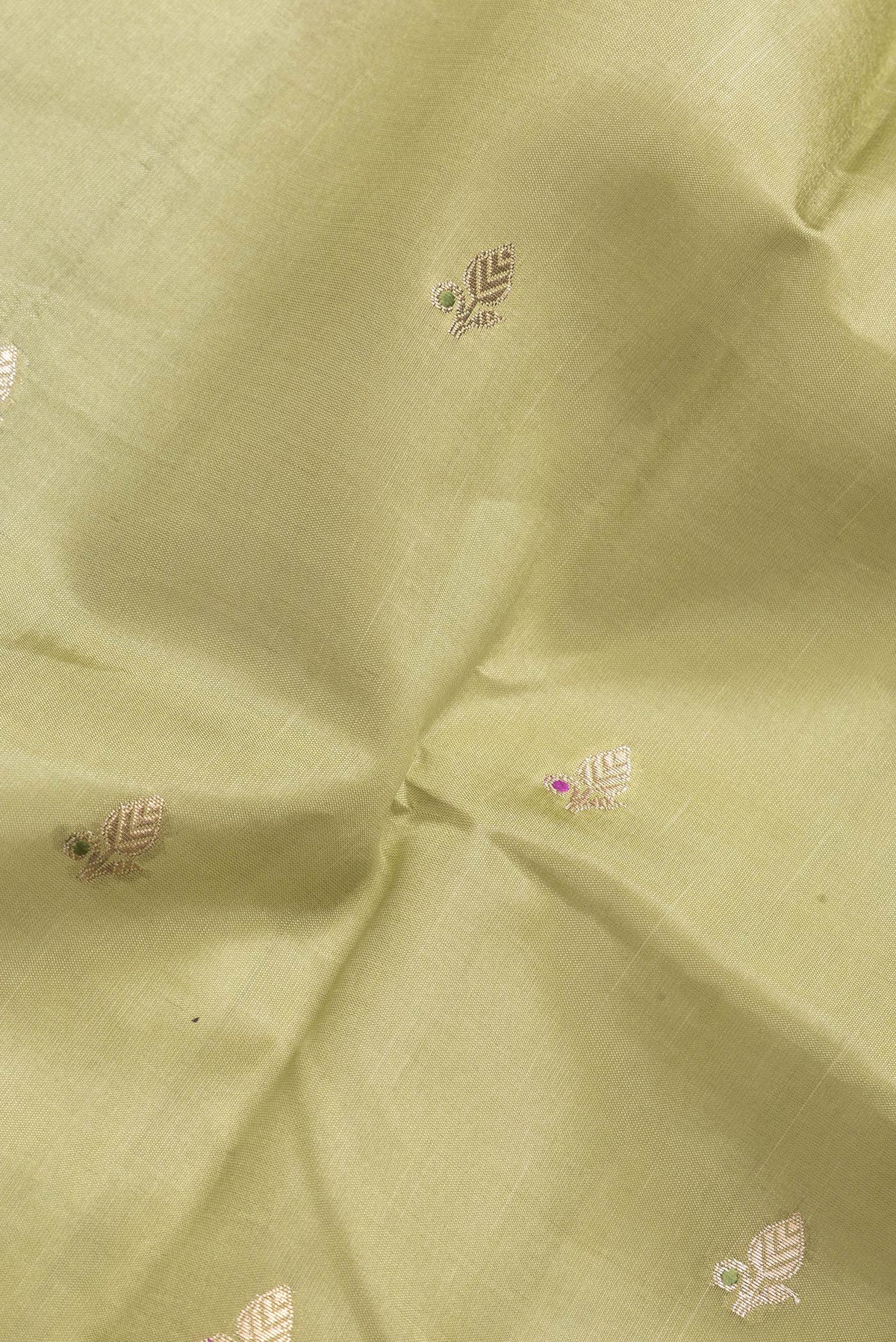 Close up of Mehandi Green Dual Tone Tussar Silk Saree with Zari Butta on the body and Fancy Border.  displaying folds