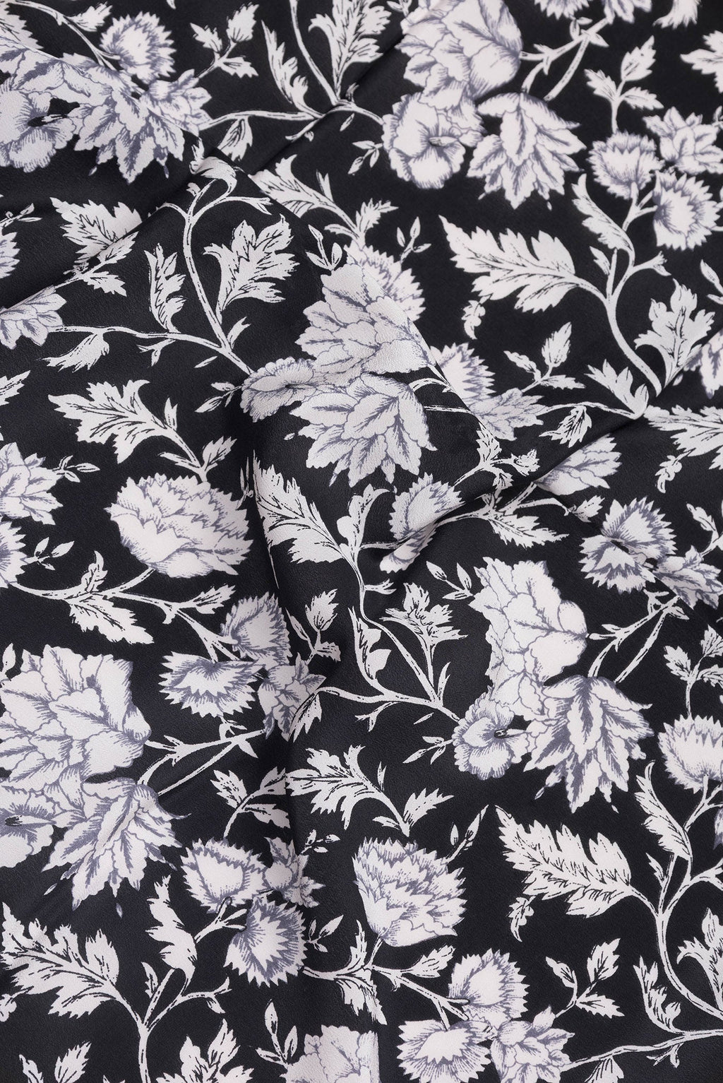 Close up of Black Dual Tone Crepe Saree with Printed design on the body and Printed Border.  displaying folds