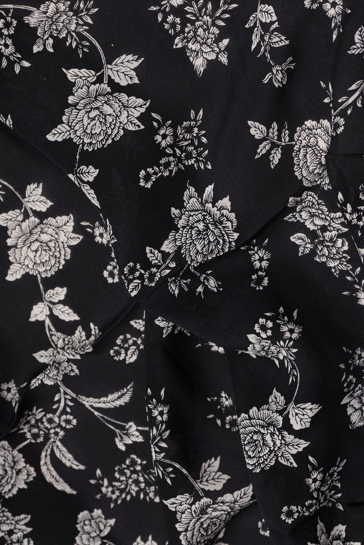 Close up of Black Dual Tone Mysore Crepe Saree with Printed design on the body and Plain Border.  displaying folds