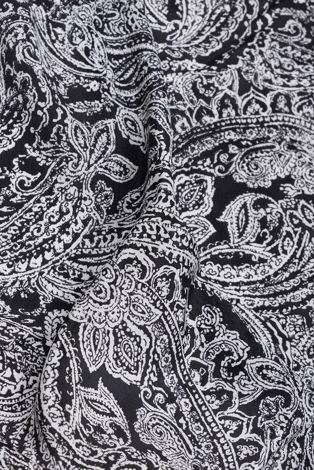 Close up of Black Crepe Saree with Printed design on the body and Printed Border.  displaying folds