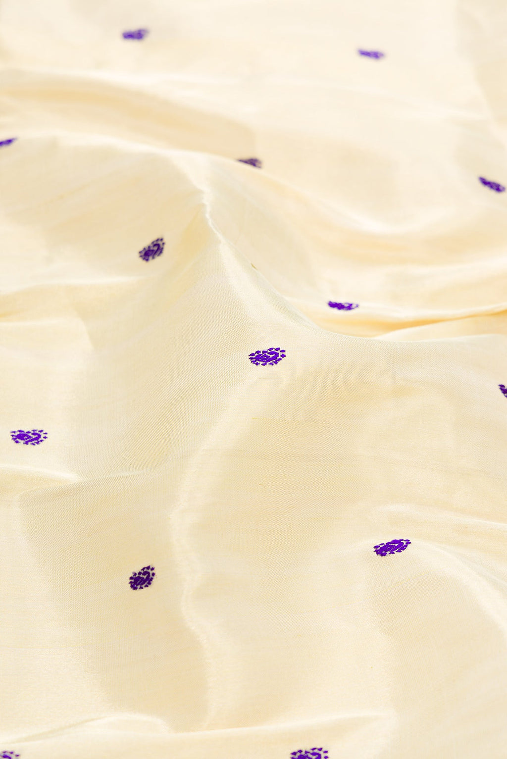 Close up of Gold Dual Tone Paithani Silk Saree with Thread Butta on the body and Paithani Border.  displaying folds