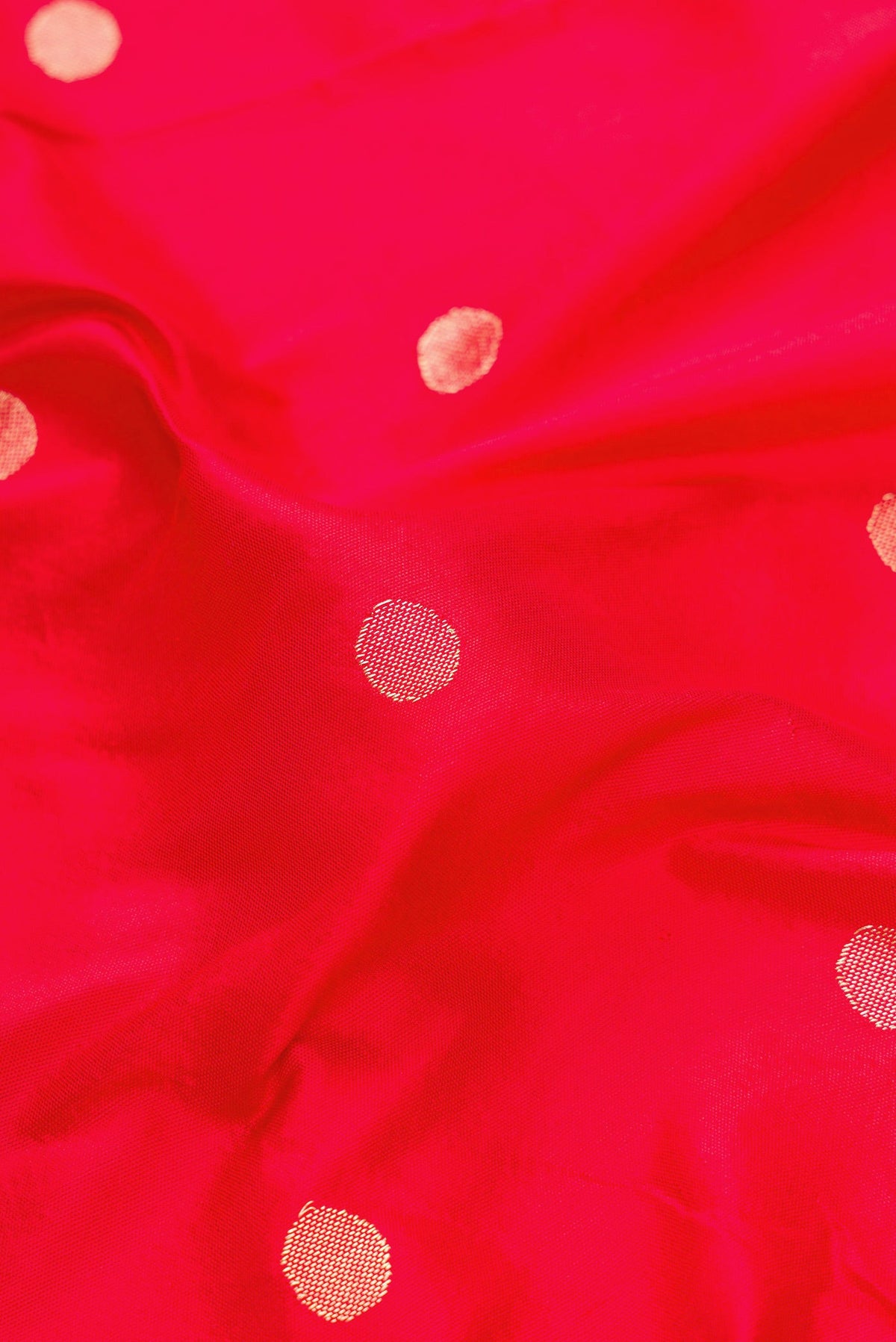 Close up of Red Dual Tone Paithani Silk Saree with Zari Butta on the body and Paithani Border.  displaying folds
