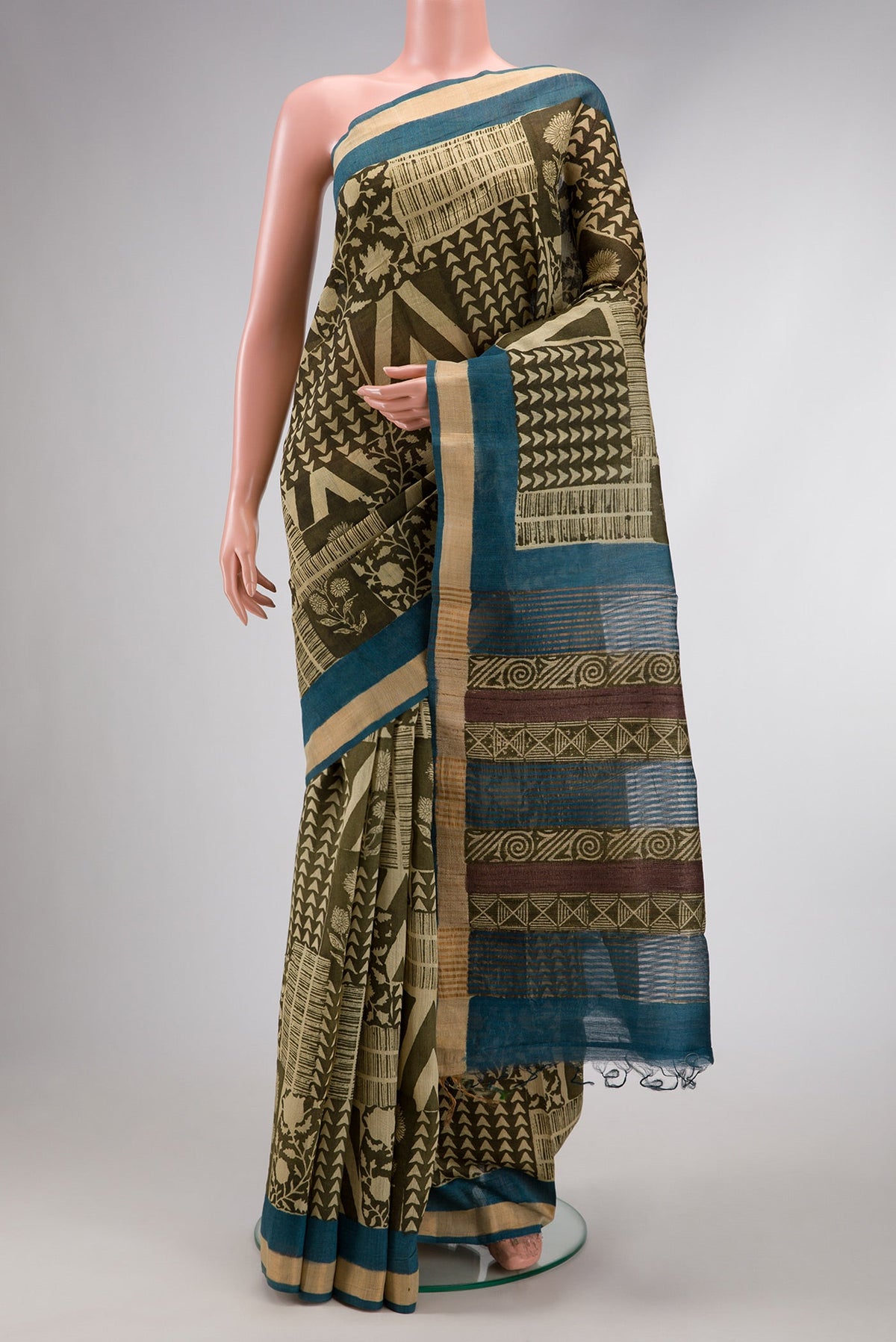 Mehandi Green Dual Tone Tussar Silk Saree with Printed design on the body and Zari Border.  displayed on a mannequin