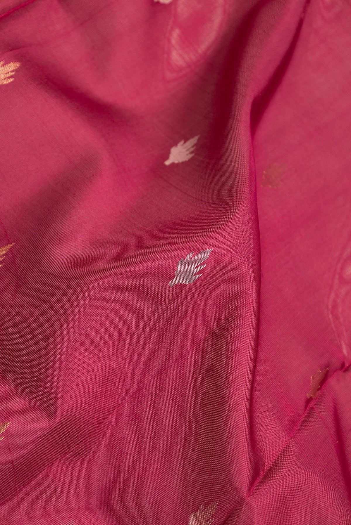 Close up of Maroon Dual Tone Uppada Silk Saree with Zari Butta on the body and Zari Border.  displaying folds