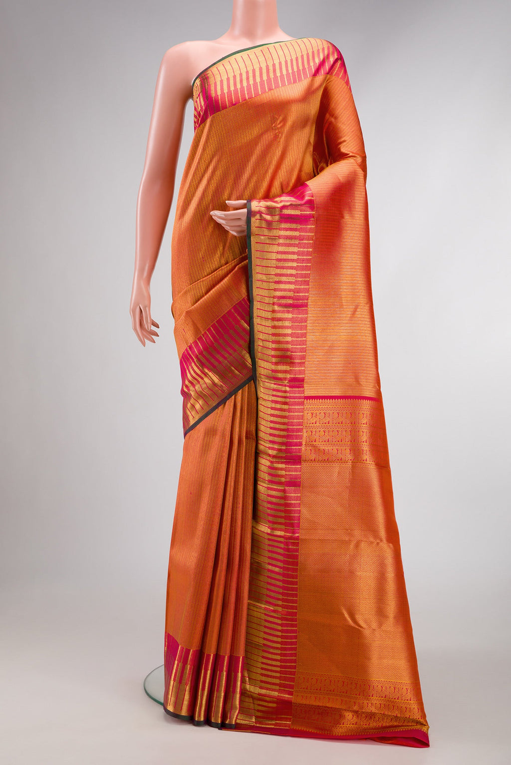 Orange Kanchipuram Silk Saree with Zari Brocade on the body and Zari Border.  displayed on a mannequin