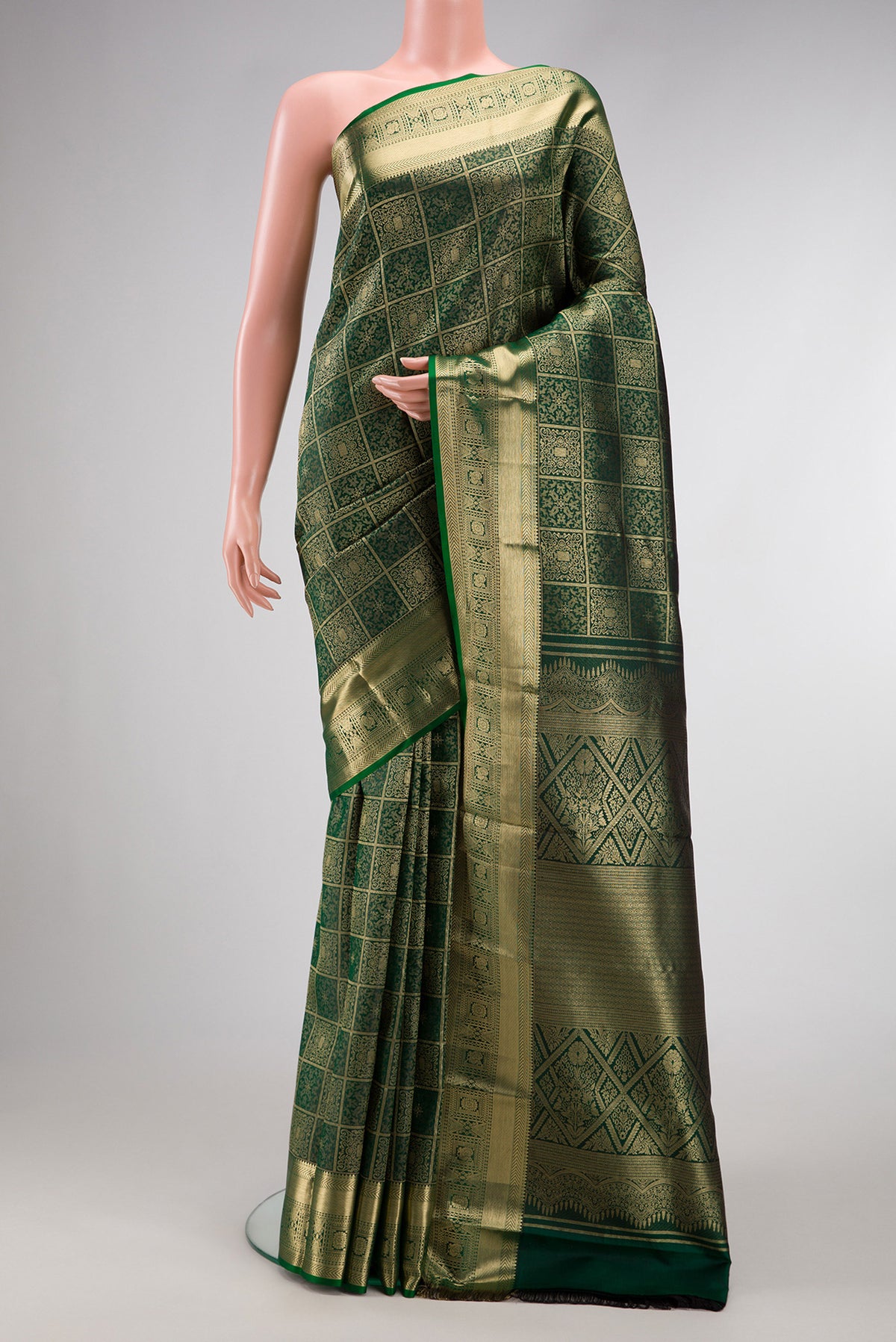 Bottle Green Kanjivaram Silk Saree with Zari Brocade on the body and Zari Border.  displayed on a mannequin
