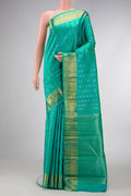 Pure Silk Pure Zari Sea Green Dual Tone Kanjivaram Saree with Zari Butta on the body and Zari Border.  displayed on a mannequin