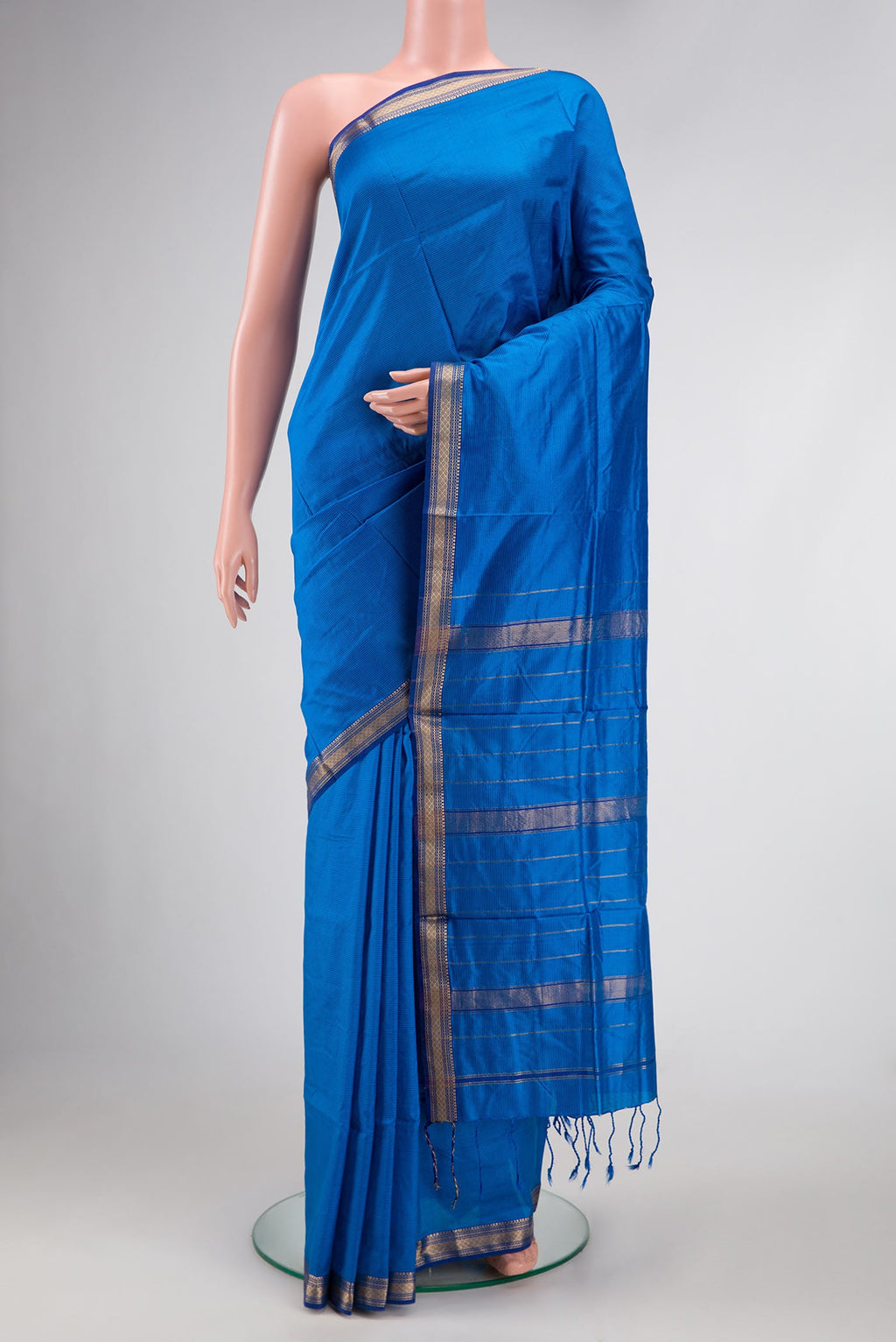 Royal Blue Dual Tone Maheshwari Silk Saree with Stripes on the body and Zari Border.  displayed on a mannequin