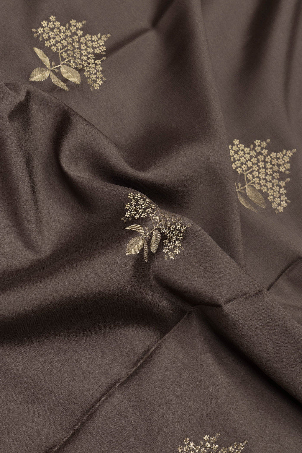 Close up of Brown Dual Tone Mysore Crepe Saree with Zari Butta on the body and Zari Border.  displaying folds