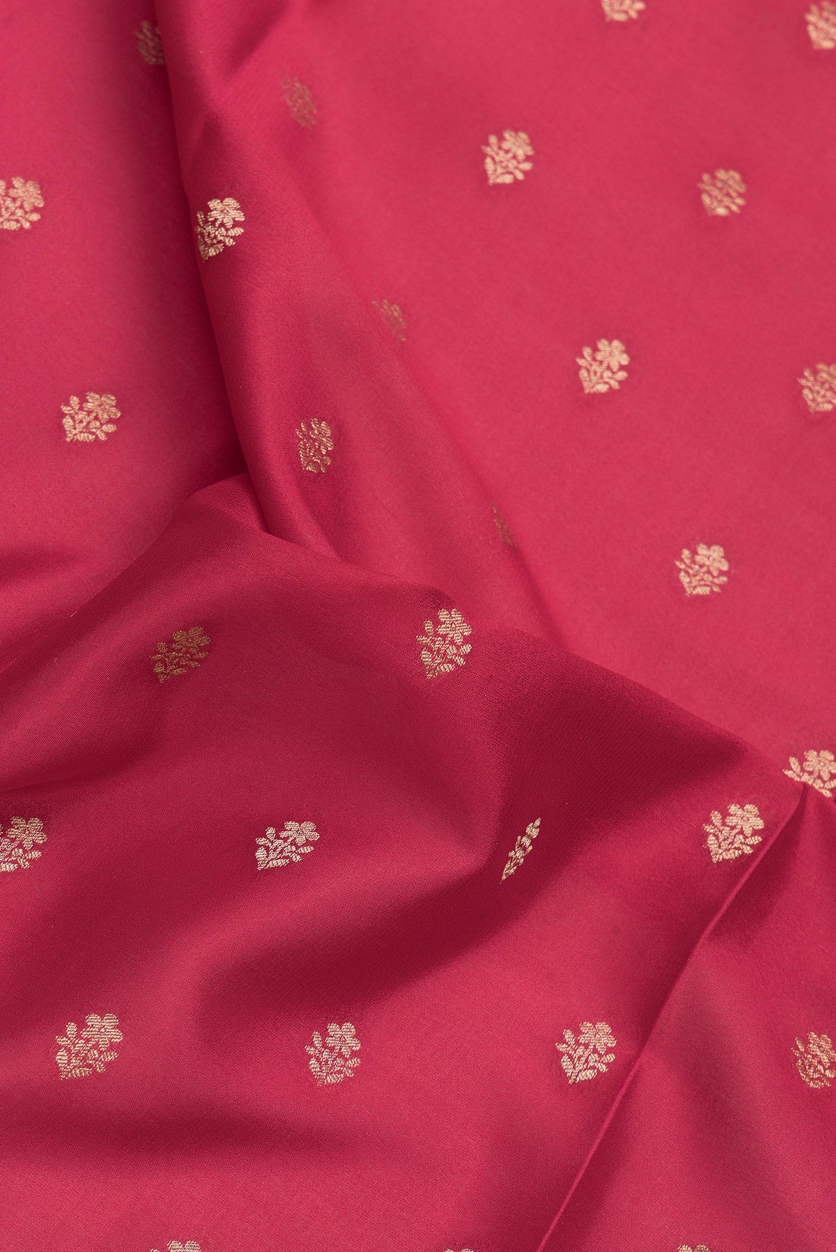 Close up of Red Mysore Crepe Saree with Zari And Thread Butta on the body and Zari Border.  displaying folds