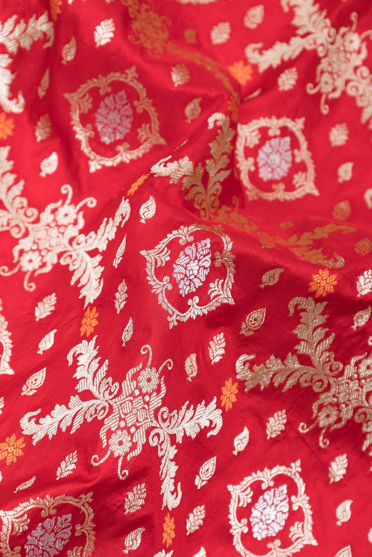Close up of Red Dual Tone Banarasi Silk Saree with Zari Brocade on the body and Zari Border.  displaying folds
