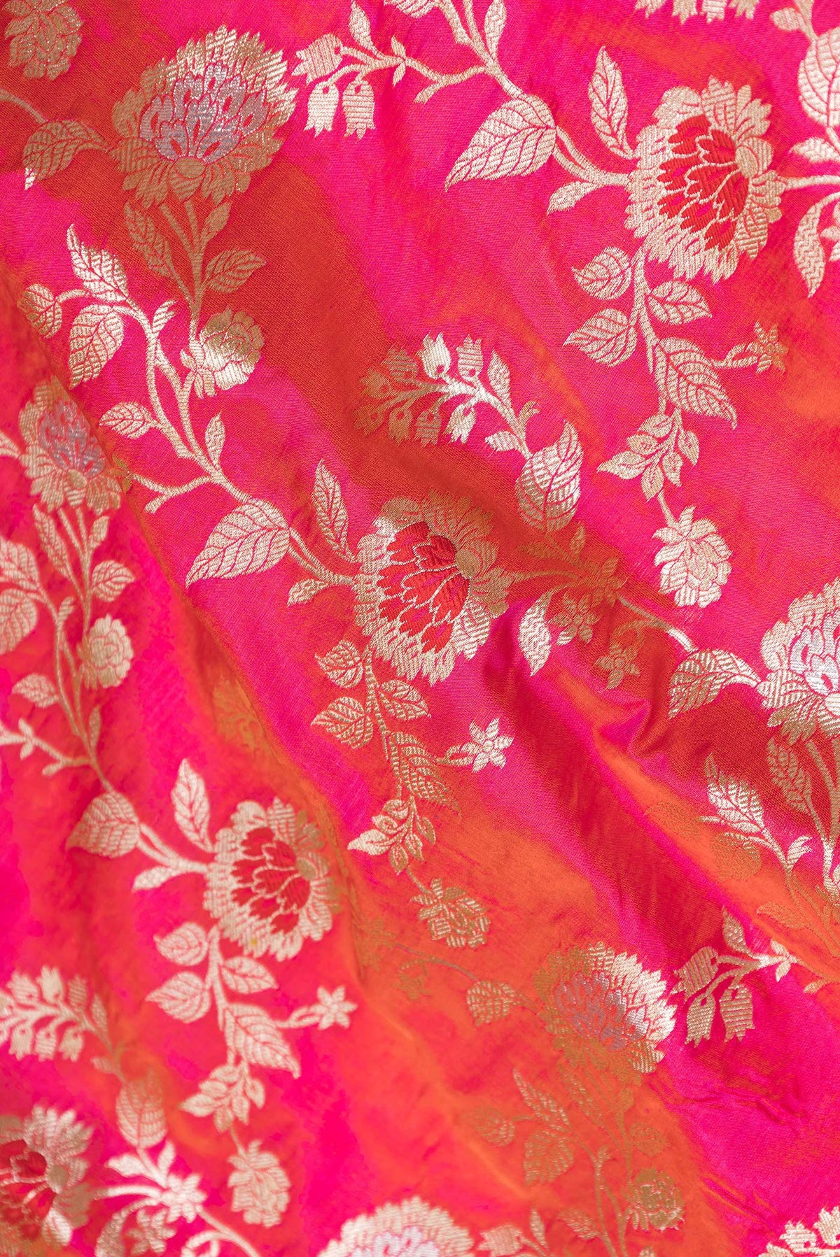 Close up of Pink Dual Tone Banarasi Silk Saree with Zari Brocade on the body and Zari Border.  displaying folds