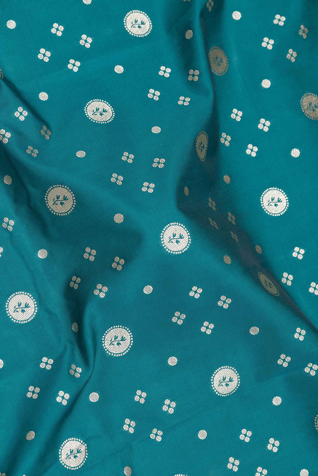 Close up of Peacock Blue Dual Tone Blended Banarasi Saree with Zari Butta on the body and Zari Border.  displaying folds