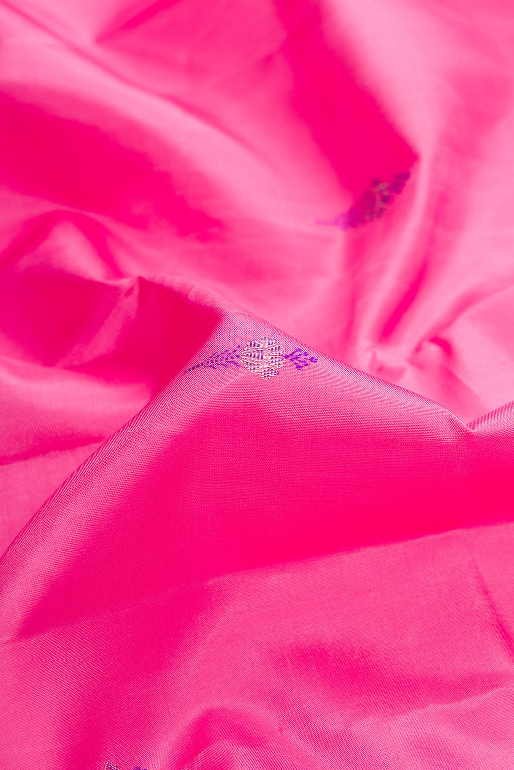 Close up of Pure Silk Pure Zari Pink Dual Tone Kanjivaram Saree with Zari Butta on the body and Fancy Border.  displaying folds