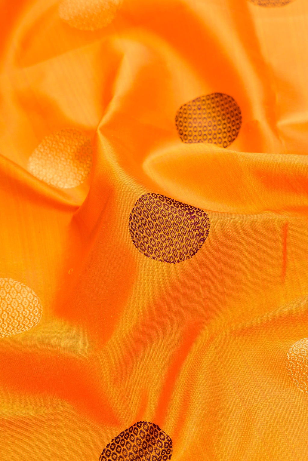 Close up of Pure Silk Pure Zari Mustard Dual Tone Kanchipuram Saree with Zari And Thread Butta on the body and Zari And Thread Border.  displaying folds