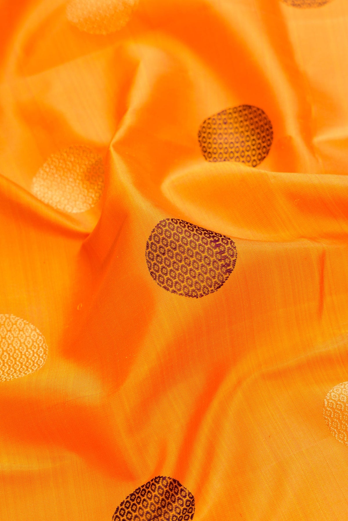Close up of Pure Silk Pure Zari Mustard Dual Tone Kanchipuram Saree with Zari And Thread Butta on the body and Zari And Thread Border.  displaying folds