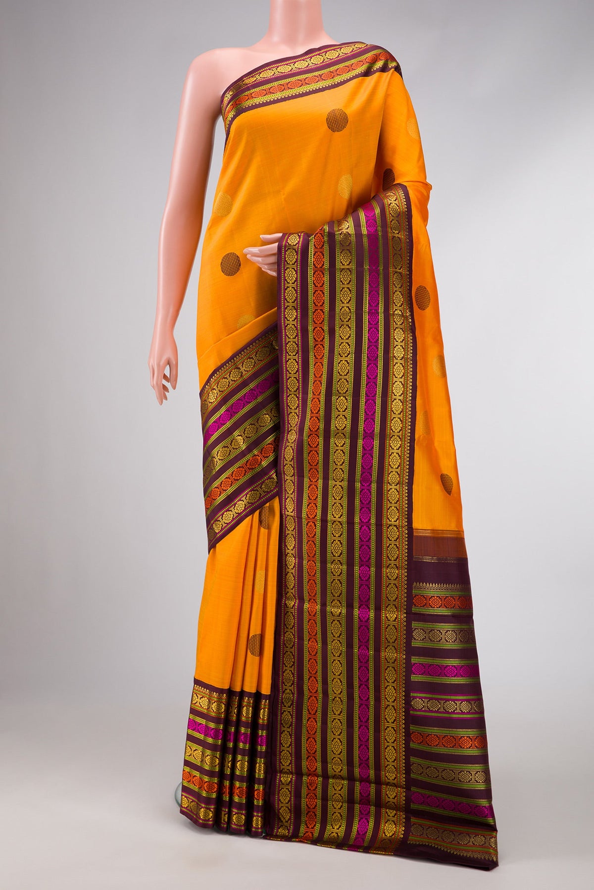 Pure Silk Pure Zari Mustard Dual Tone Kanchipuram Saree with Zari And Thread Butta on the body and Zari And Thread Border.  displayed on a mannequin