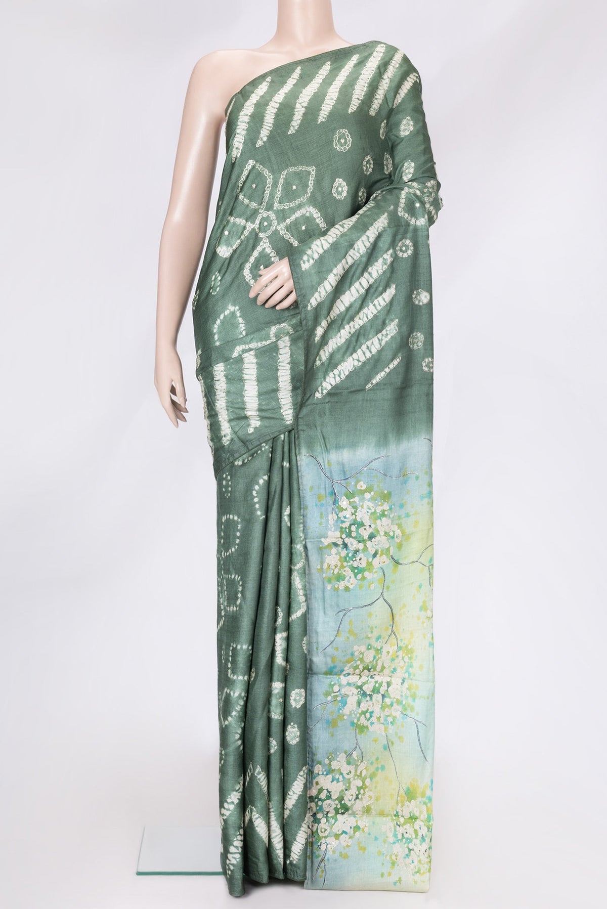 Mehandi Green Dual Tone Tussar Silk Saree with Embroidery on the body and Without Border.  displayed on a mannequin