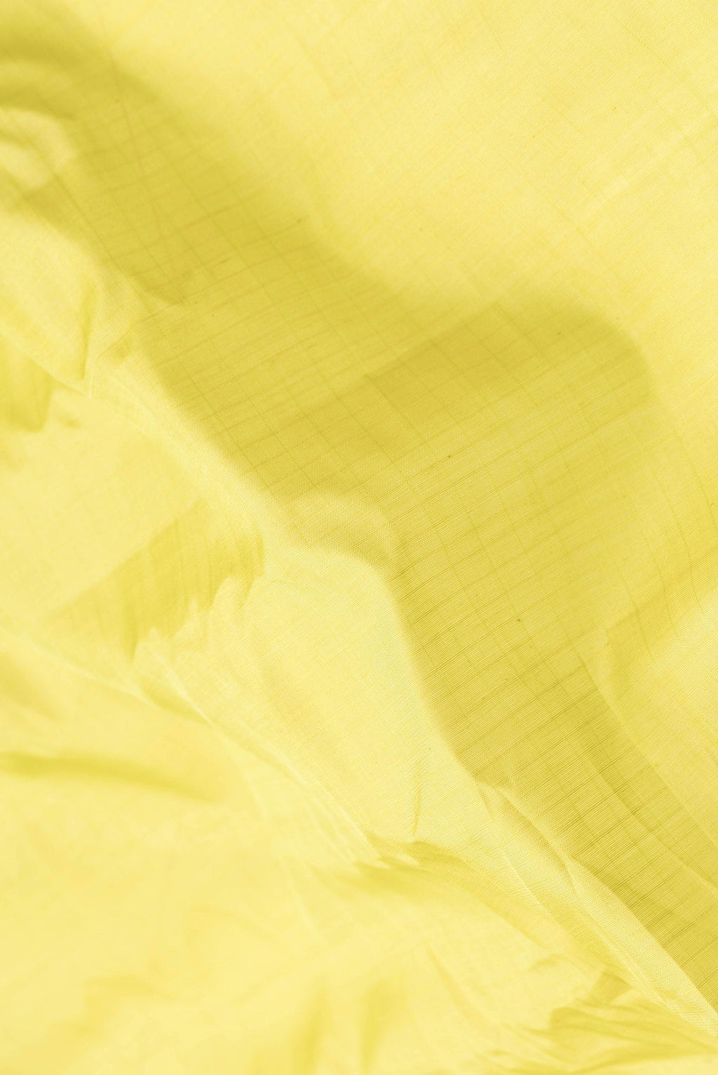 Close up of Parrot Green Dual Tone Gadwal Silk Saree with Checked design on the body and Temple Border.  displaying folds