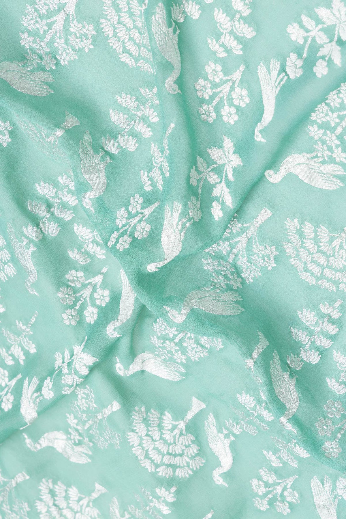 Close up of Sea Green Dual Tone Banarasi Georgette Saree with Zari Brocade on the body and Zari Border.  displaying folds