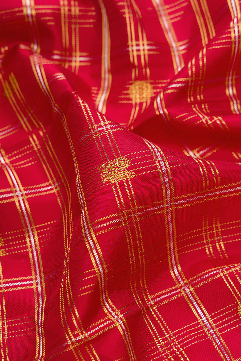 Close up of Red Kanjivaram Silk Saree with Checked design on the body and Zari Border.  displaying folds