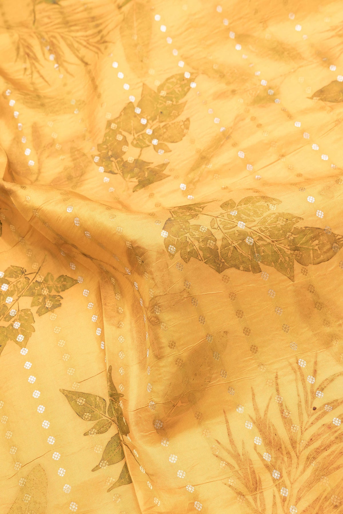 Close up of Mustard Dual Tone Kanchipuram Silk Saree with Printed design on the body and Zari Border.  displaying folds