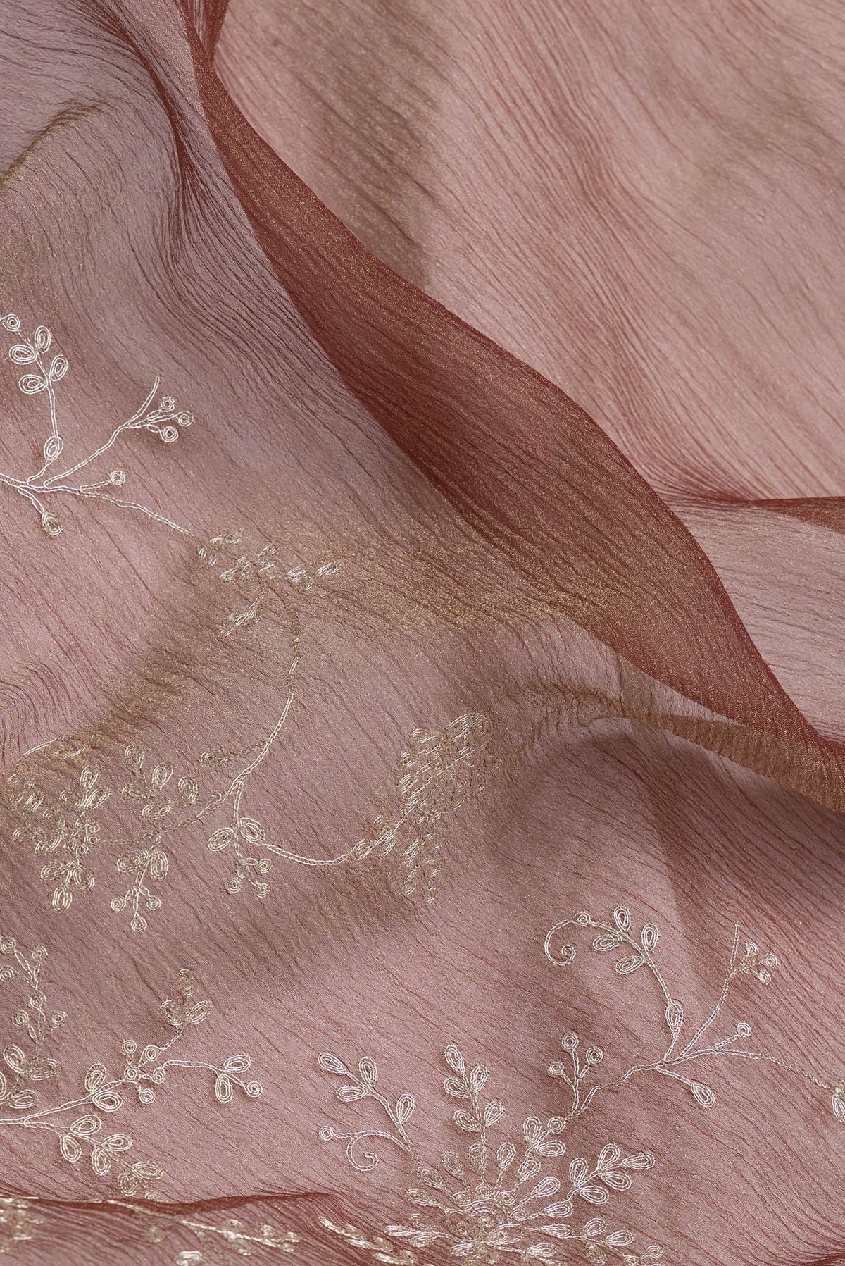 Close up of Brown Dual Tone Organza Silk Saree with Embroidery on the body and Embroidery Border.  displaying folds