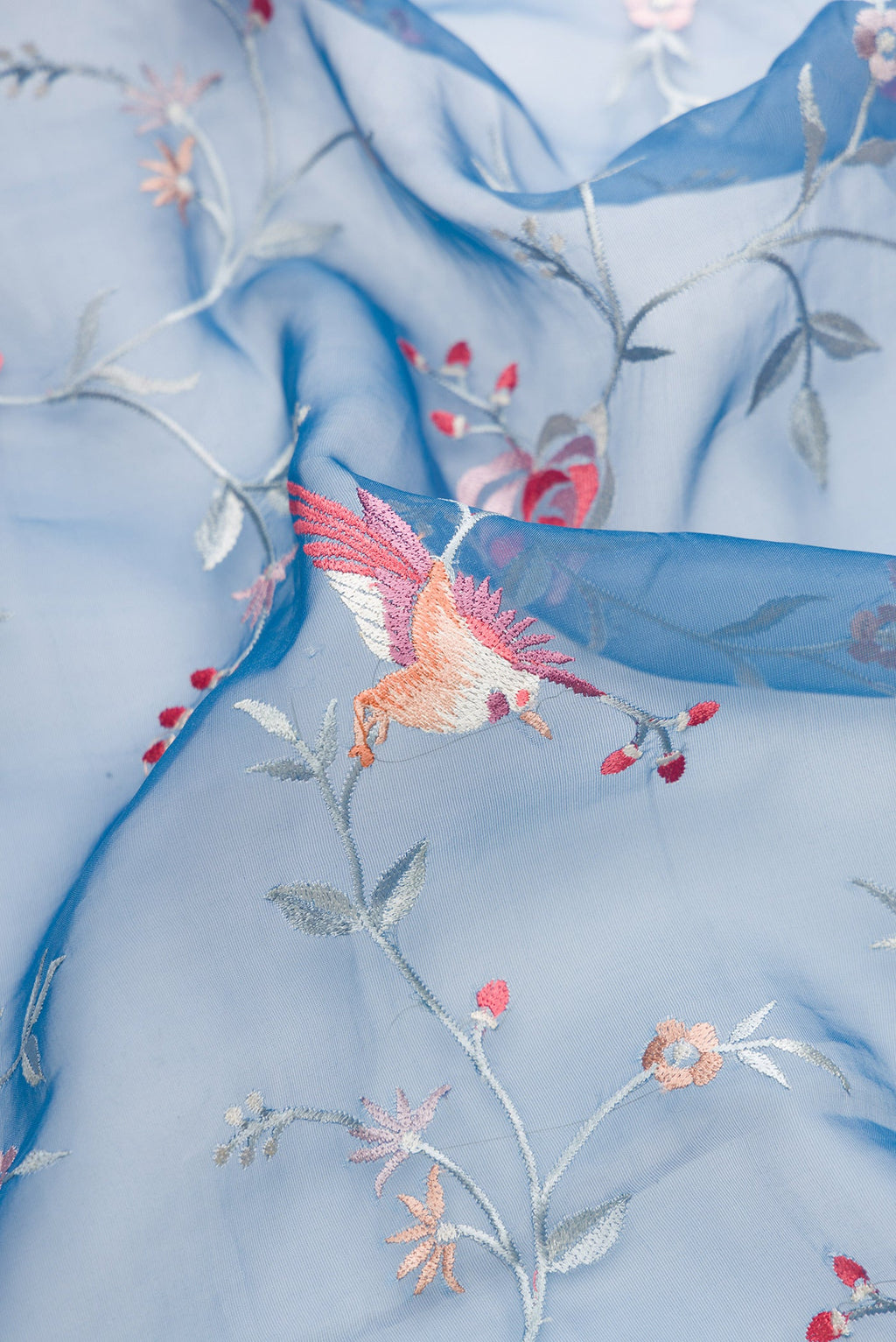 Close up of Maya Blue Dual Tone Organza Silk Saree with Embroidery on the body and Embroidery Border.  displaying folds