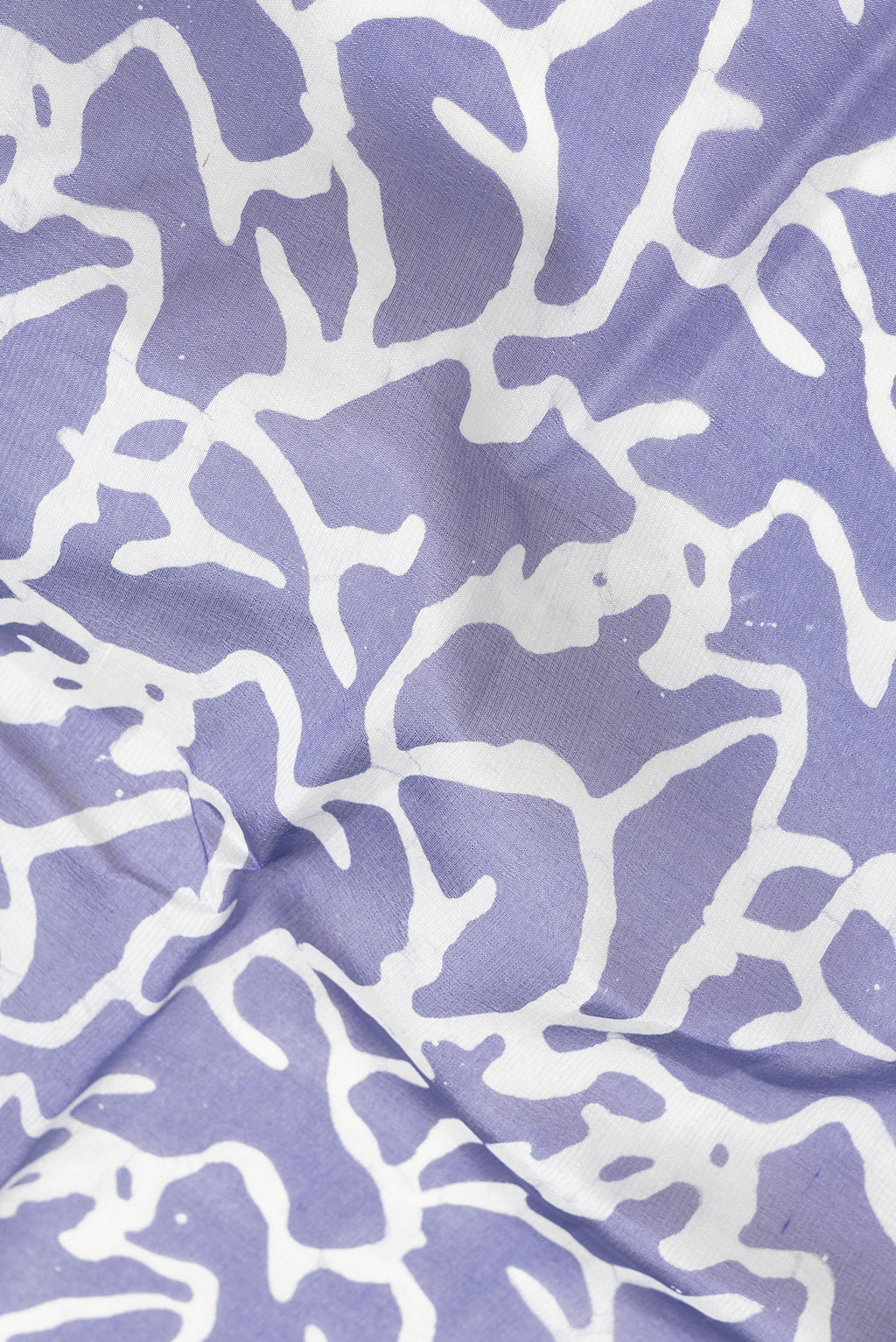 Close up of Violet Dual Tone Tussar Silk Saree with Printed design on the body and Printed Border.  displaying folds