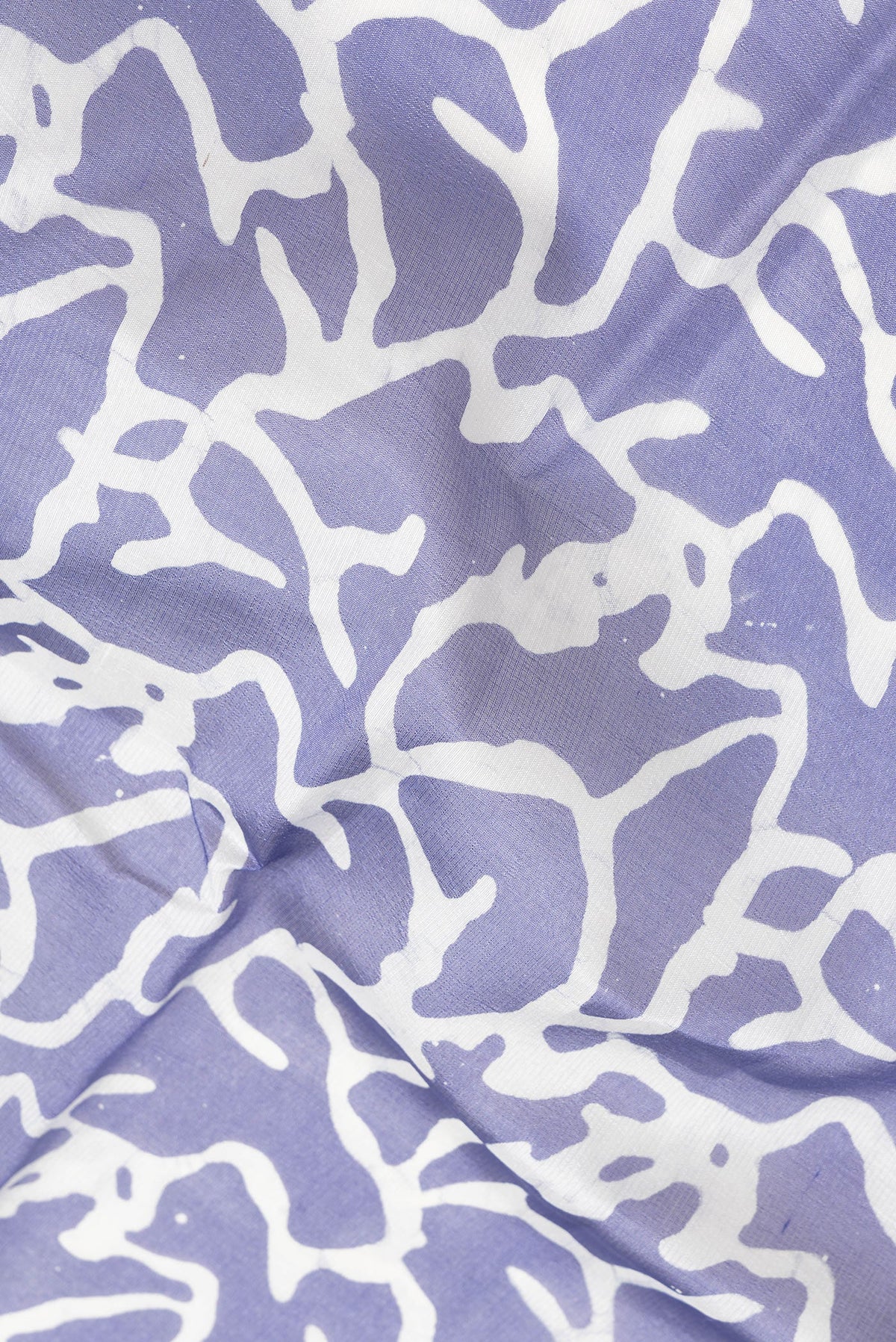 Close up of Violet Dual Tone Tussar Silk Saree with Printed design on the body and Printed Border.  displaying folds