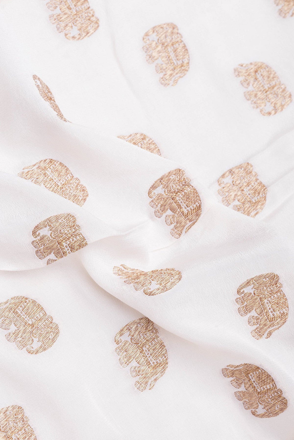 Close up of Off White Banarasi Georgette Saree with Zari Butta on the body and Zari Border.  displaying folds