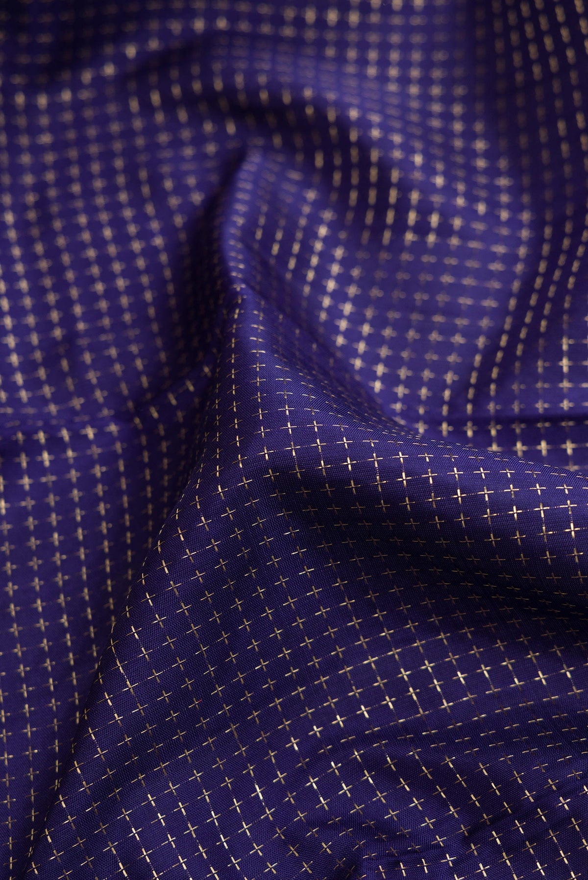 Close up of Navy Blue Dual Tone Kanjivaram Silk Saree with Checked design on the body and Zari Border.  displaying folds