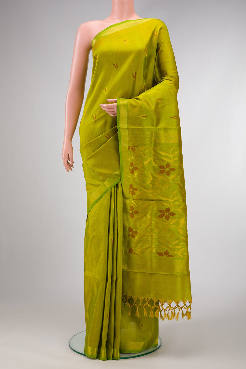 Parrot Green Dual Tone Uppada Silk Saree with Zari And Thread Butta on the body and Zari Border.  displayed on a mannequin