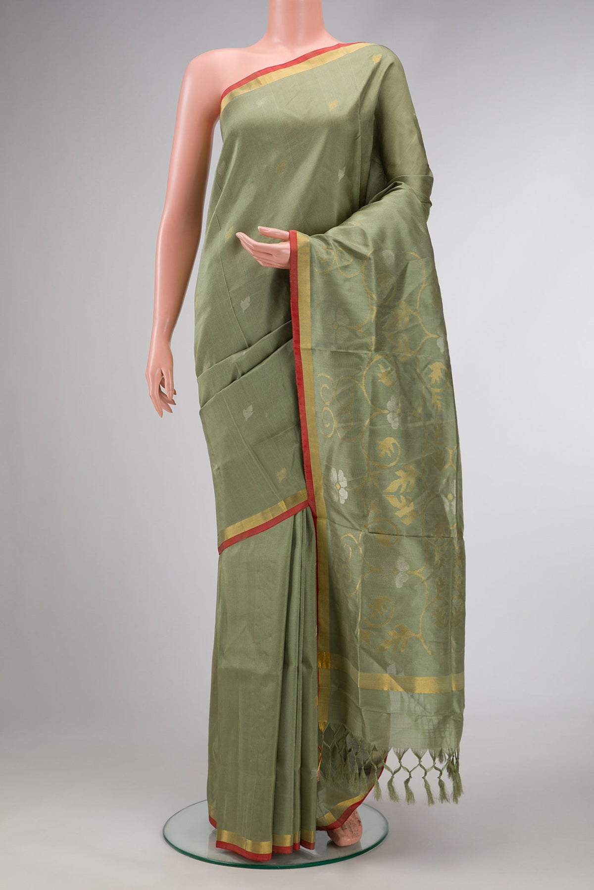 Light Green Dual Tone Soft Silk Saree with Zari Butta on the body and Zari Border.  displayed on a mannequin