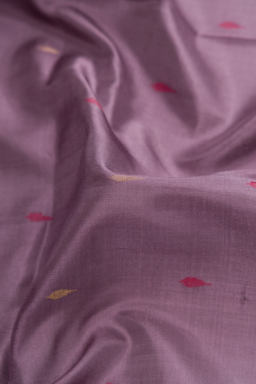 Close up of Purple Dual Tone Uppada Silk Saree with Zari And Thread Butta on the body and Zari Border.  displaying folds